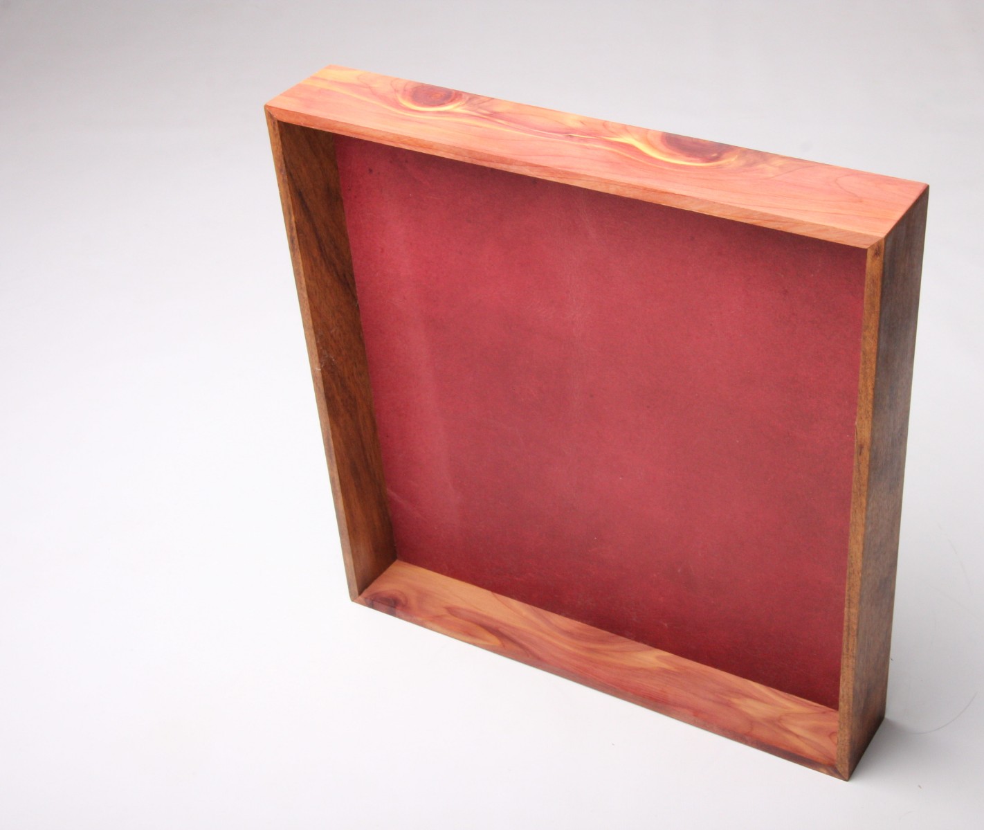 Aromatic cedar display with crimson leather panel