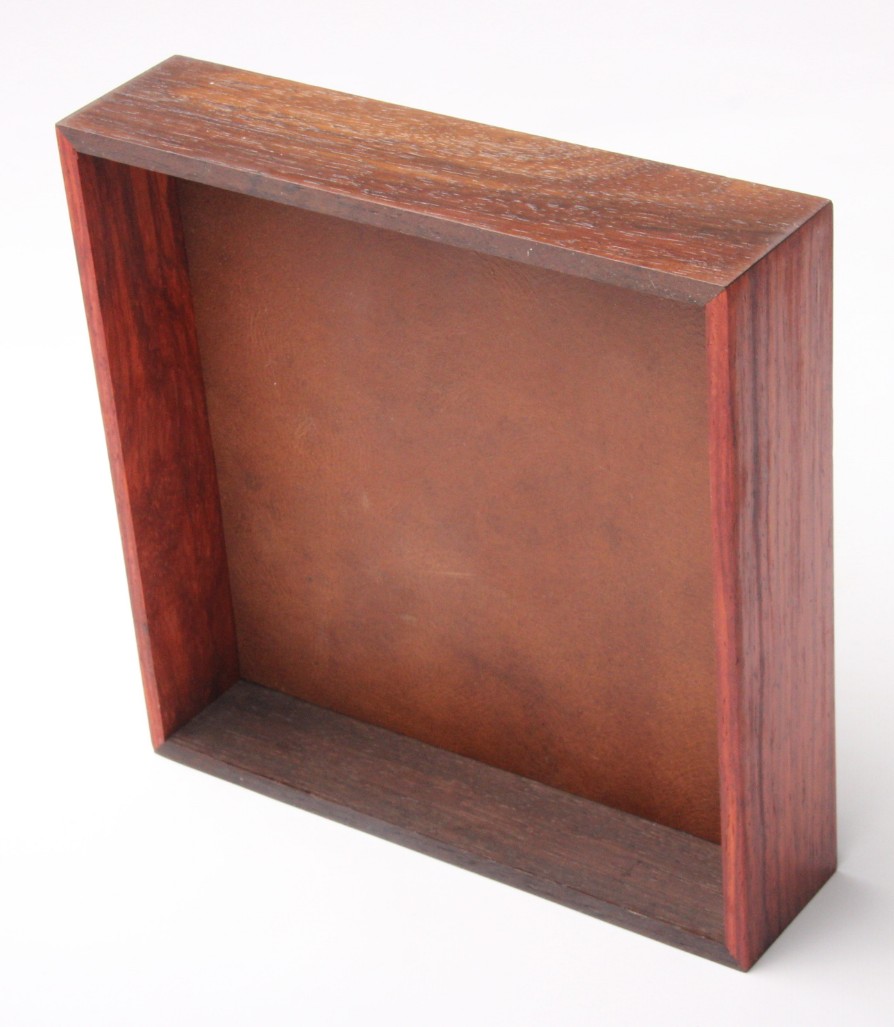 Dark hardwood display with copper leather well