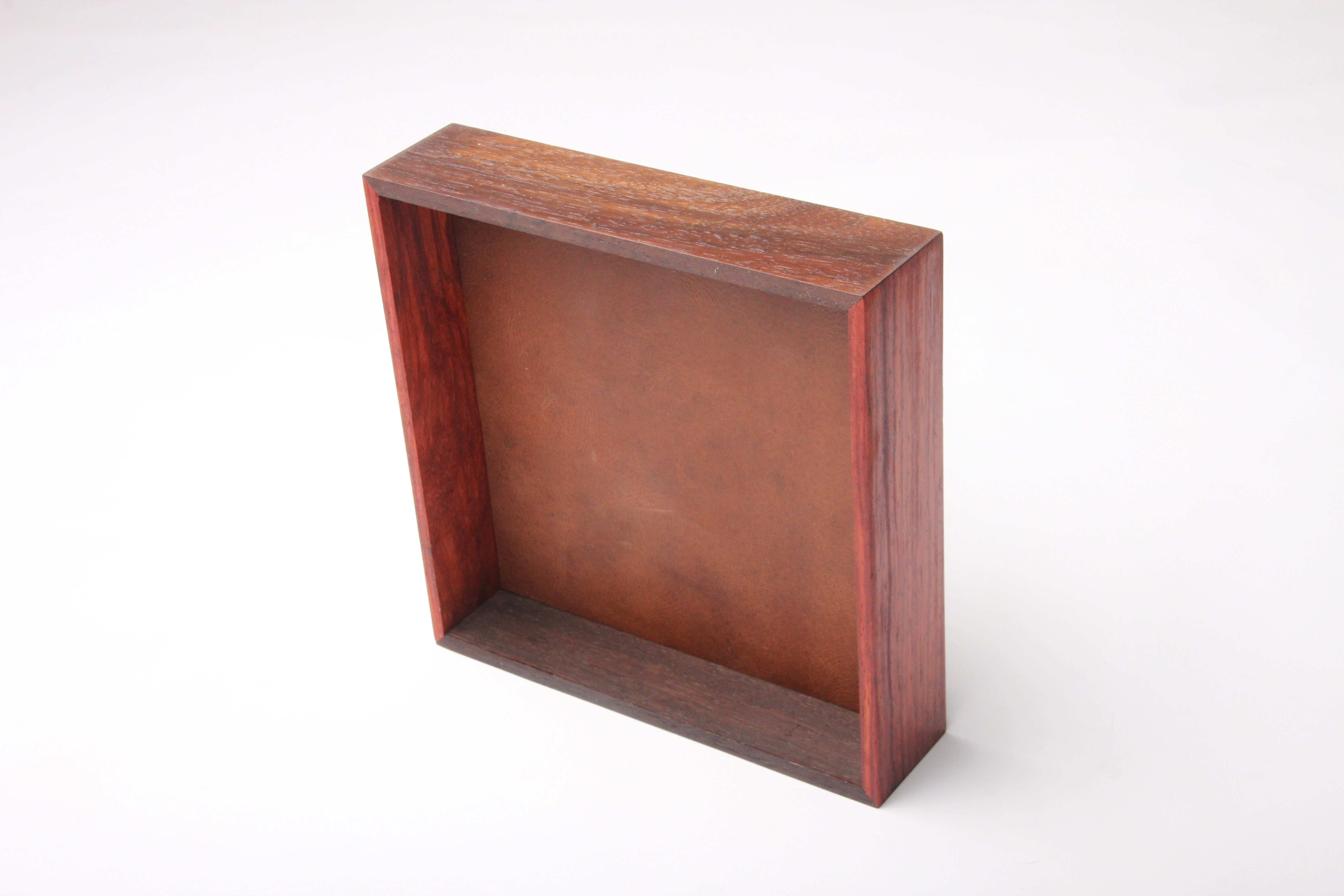 Dark hardwood display with copper leather well