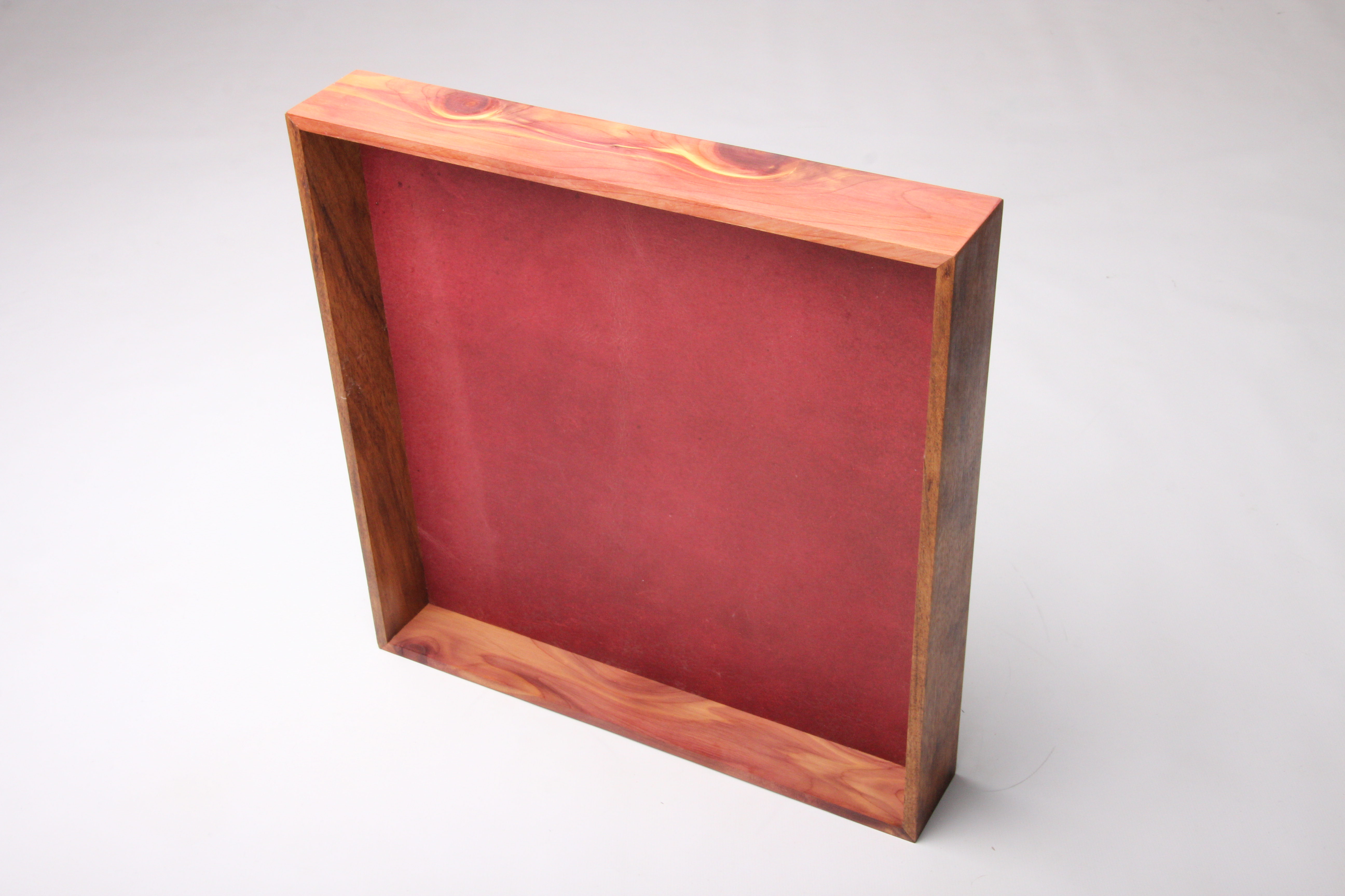Aromatic cedar display with crimson leather panel
